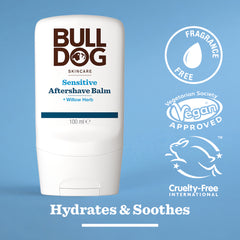 The Bulldog Sensitive Aftershave Balm, in a white bottle for sensitive skin, sits on a blue background with icons for Fragrance Free, Vegan Approved, and Cruelty-Free. Text reads: Hydrates & Soothes with natural origin ingredients.